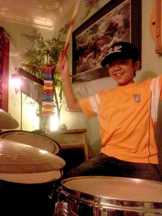 Image of Hayato Suzuki drumming by Angie Mack