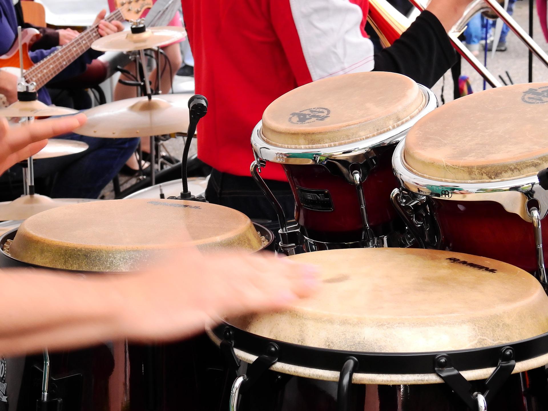 Hands playing drums in a drum circle
